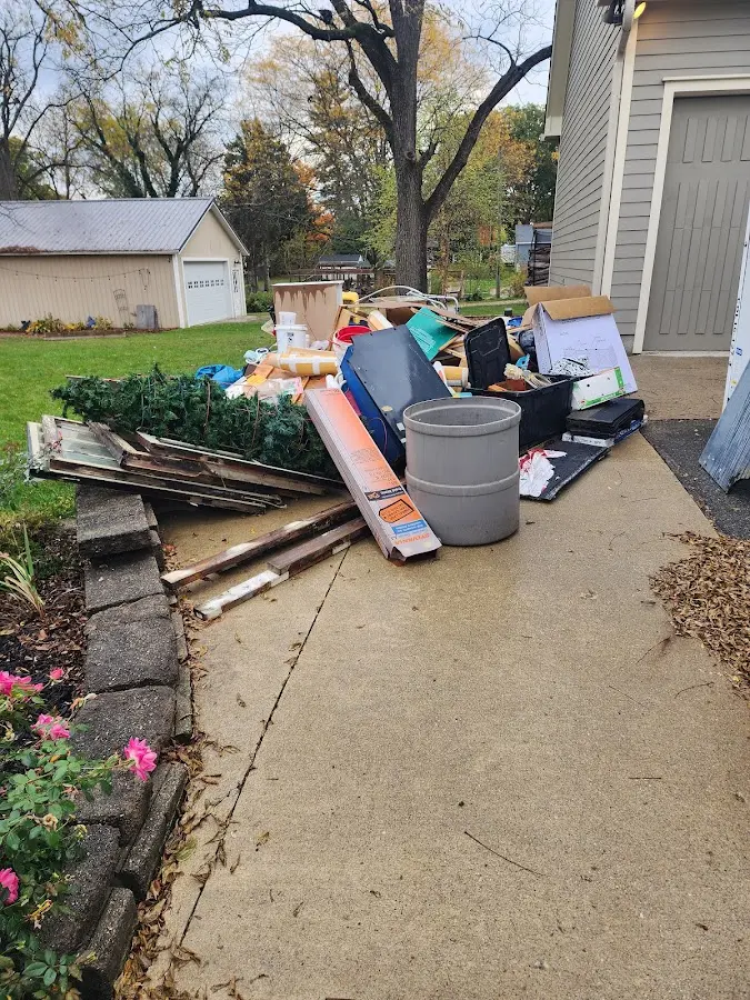 Dumpster being loaded with debris for Commercial Dumpster Rental in Avenue B and C